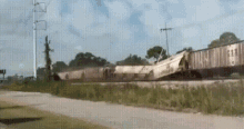 a train is going down the tracks with the letters nm on the side of it