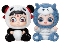 a panda and an owl stuffed animal are sitting next to each other on a white background