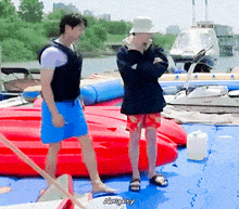 a couple of men standing on a dock with the word almighty written on the bottom