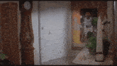 a room with a clock and a painting on the wall