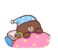 a brown bear wearing a sleep cap is laying on a bed with a yellow duck