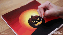 a person is painting a pumpkin on a canvas that is made in animatica