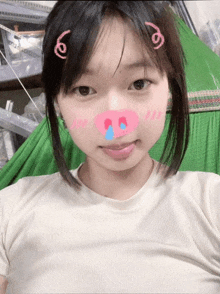 a girl with a pig nose has a sticker on her face