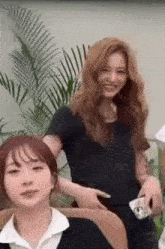 a woman is sitting in a chair next to another woman .