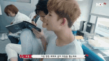 a group of people are sitting in a room with a sign that says mx on it