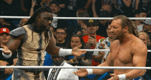 two men in a wrestling ring one of whom is wearing a hat that says ram