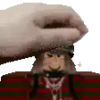 a pixel art of a person putting a towel on a cartoon character 's head .