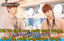 two men are standing next to each other in a kitchen and one of them is talking about small things .