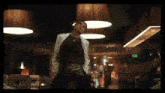 a man in a lab coat stands in a dark room