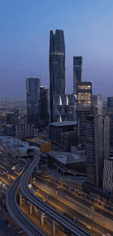 an aerial view of a city skyline with a highway going through the middle