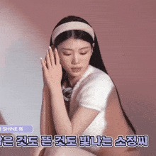 a woman wearing a headband with the word shine on the bottom left