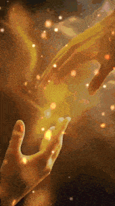 a couple of hands reaching out towards each other with glowing lights in the background
