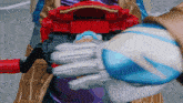 a person wearing a glove with a blue and white sphere on it
