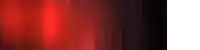 a person is standing in a dark room with a red light coming out of the ceiling .