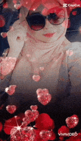 a woman wearing sunglasses and a hijab surrounded by hearts
