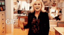a woman is dancing in a living room with the word gif in the background