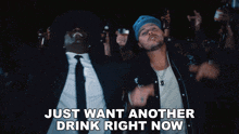 a man in a blue hat is dancing with the words just want another drink right now