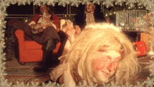 a man in a wig is laying on the floor in front of a red box that says bock on it