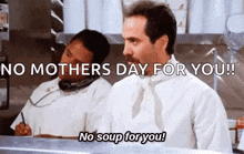 a man with a mustache is standing in a kitchen talking on a phone and says `` no mothers day for you ! ''