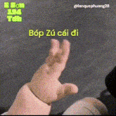 a close up of a baby 's hand with the words bop zu cai di written on the bottom