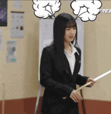 a woman in a suit is holding a stick with speech bubbles coming out of her head .
