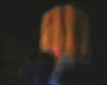 a blurry picture of a person 's face with a purple and red background