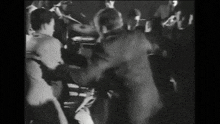 a black and white photo of a crowd of people
