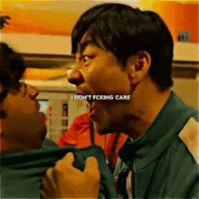 a man in a green jacket is screaming at another man .