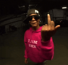 a person wearing a pink shirt that says i am sex on it