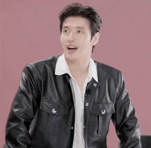 a man in a black leather jacket and white shirt