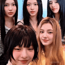 a group of young women are posing for a picture and one of them is wearing a yellow shirt with the name nizaerie on it