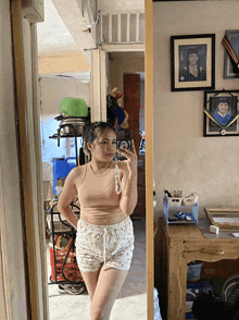 a woman taking a selfie in front of a mirror