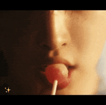 a close up of a person eating a lollipop