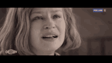a close up of a woman 's face with a tear running down her face