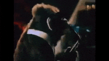 a monkey is wearing sunglasses and a tuxedo and playing a saxophone .