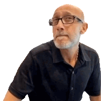 a bald man with glasses and a beard looks to the side