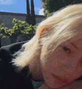 a close up of a woman 's face with blonde hair