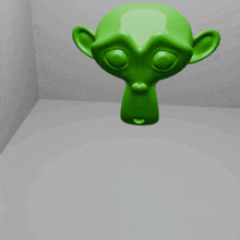 a green monkey head hanging from the ceiling in a room