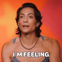 a woman says " i 'm feeling " in front of a red background