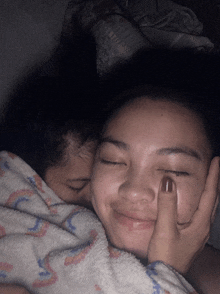 a woman kissing another woman on the forehead
