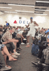 a man is dancing in front of a sign that says delta