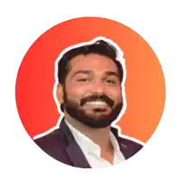 a man with a beard is smiling in front of a red circle