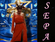 a woman in a red dress stands in front of a sign that says supernova