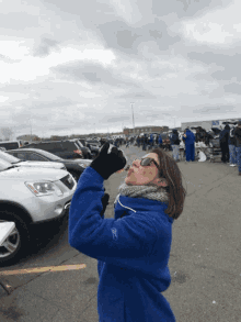 a woman wearing a blue sweatshirt with the word reebok on it