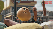 two sausages are standing next to each other in front of a building that says sausage party