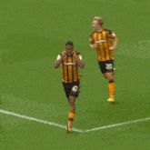 a soccer player wearing number 21 is hugging another player