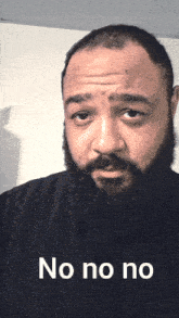 a man with a beard is wearing a black shirt with the words no no no on it