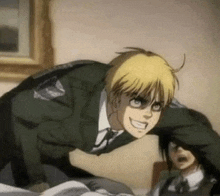 a man in a suit and tie is laying on a bed with another man .