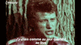 a man is crying in front of a tree with the words " j y crois comme au jour quand il se leve " written below him