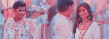 a man and a woman are standing next to each other and talking to each other .